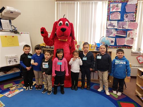 PreK students standing in front of Clifford the Big Red Dog in a Prek Classroom  